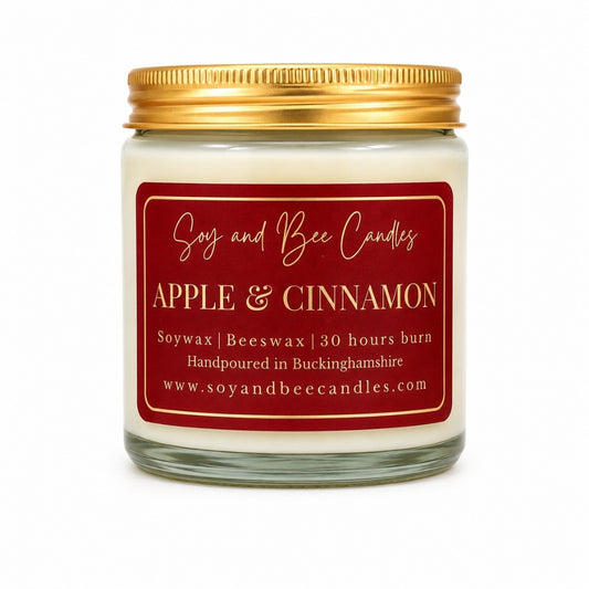 Candle jar with 'Apple & Cinnamon' label on a white background