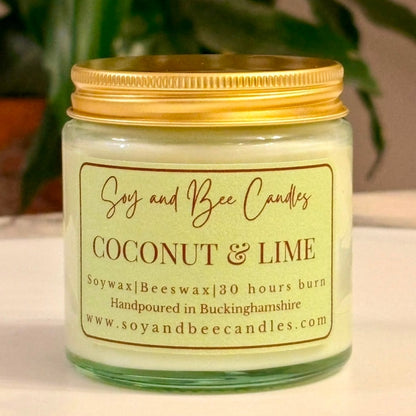 Soy and Bee Candles coconut & lime candle with a gold lid on a neutral background