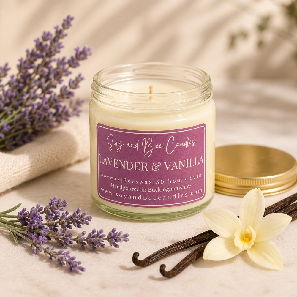 Soy and Bee Candles lavender and vanilla candle with lavender, vanilla beans, and a vanilla flower on a light background.