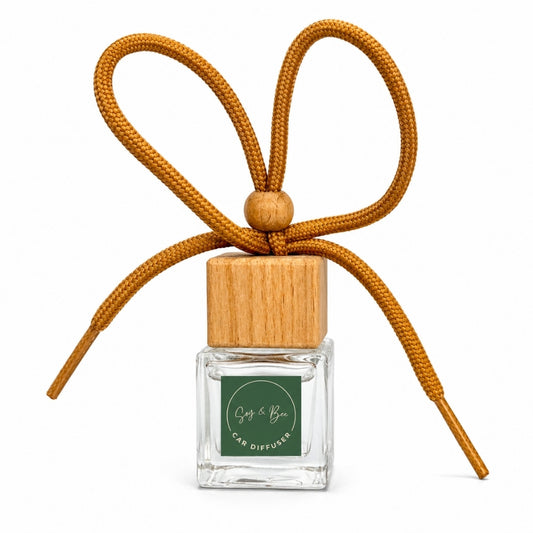 Car diffuser with wooden cap and orange cord on a white background