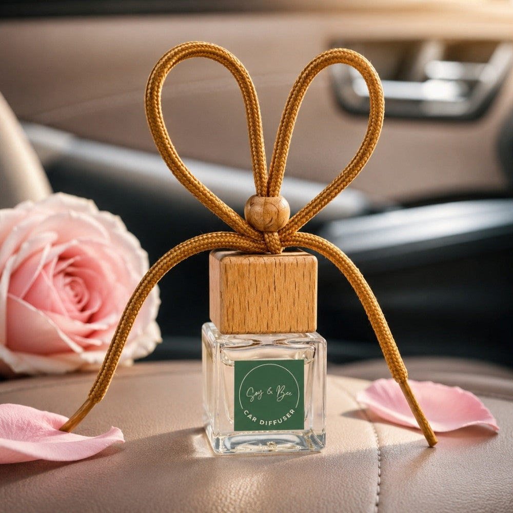 Car diffuser with wooden cap and pink roses on a car dashboard