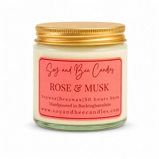 Soy and Bee Candles rose & musk candle with a gold lid on a white background