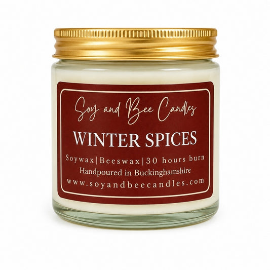 Soy and Bee Candles Winter Spices candle with a gold lid on a white background