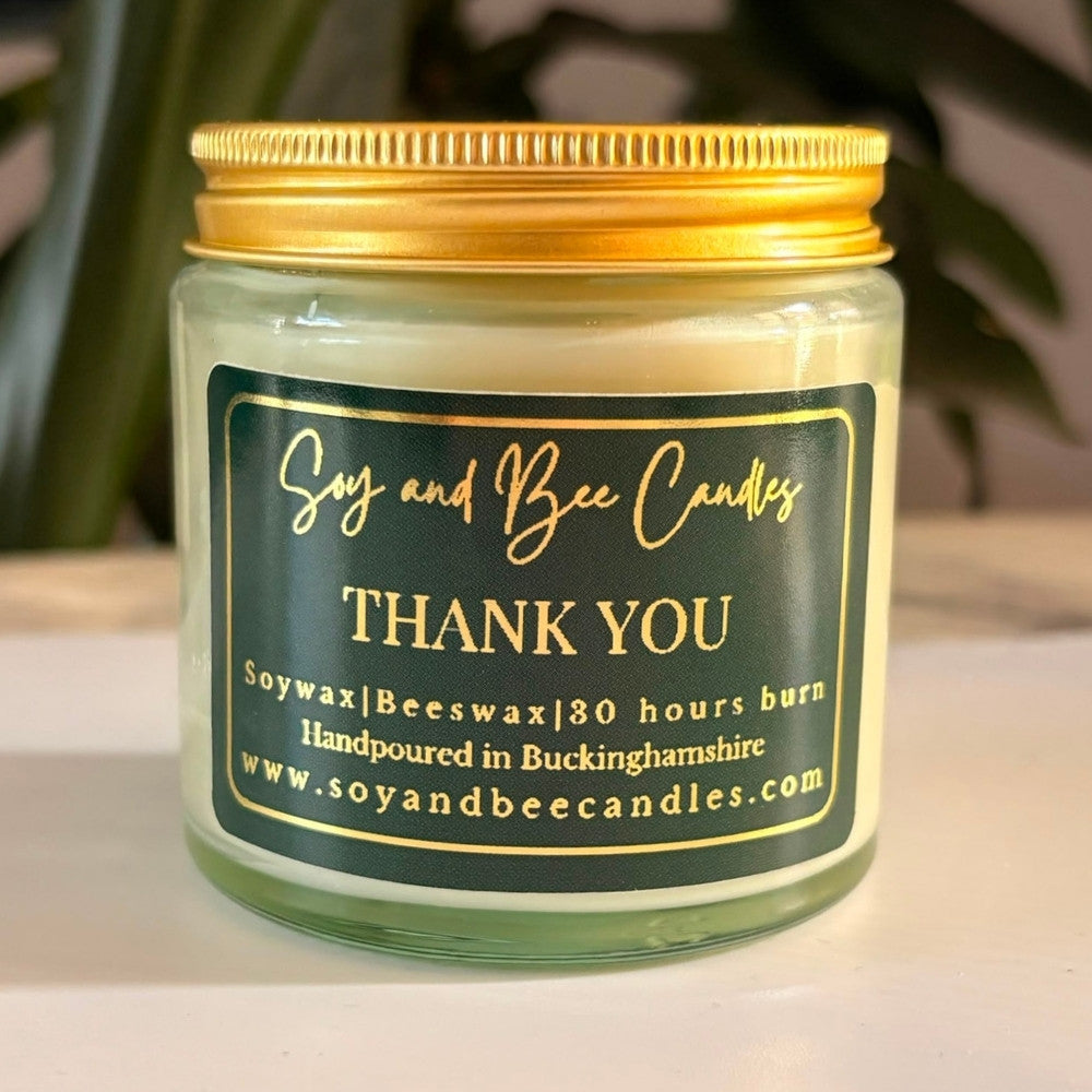 Soy and Bee Candles jar with a 'Thank You' label on a neutral background